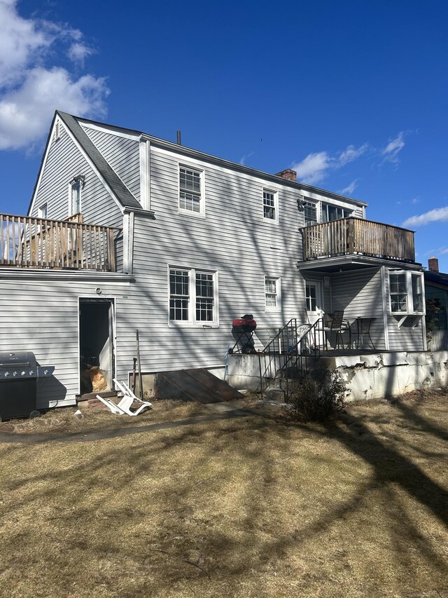 rear view of property featuring a balcony