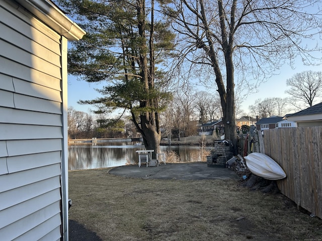 view of yard featuring a water view and fence