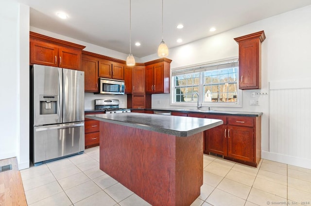 kitchen with sink, hanging light fixtures, light tile patterned floors, a kitchen island, and stainless steel appliances