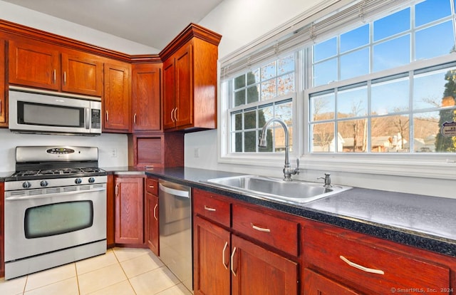 kitchen featuring sink, light tile patterned floors, and stainless steel appliances