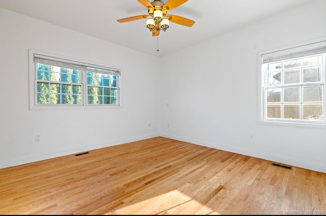 empty room with light hardwood / wood-style floors and ceiling fan