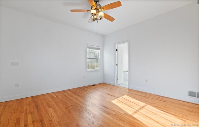 empty room featuring light hardwood / wood-style flooring and ceiling fan