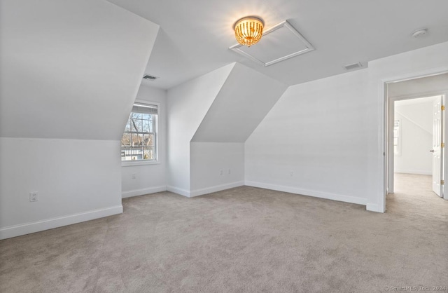 bonus room featuring light carpet and vaulted ceiling