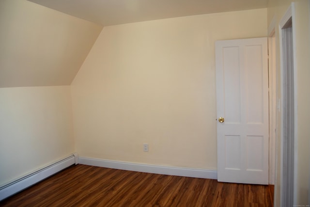 additional living space featuring vaulted ceiling, dark wood-type flooring, and a baseboard heating unit