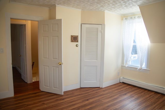 unfurnished bedroom featuring ornamental molding, dark wood-type flooring, a baseboard radiator, and multiple windows