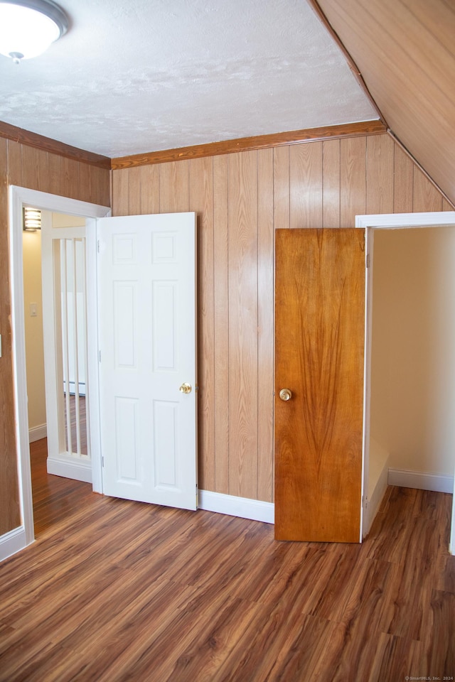 unfurnished bedroom featuring dark hardwood / wood-style floors and a baseboard radiator