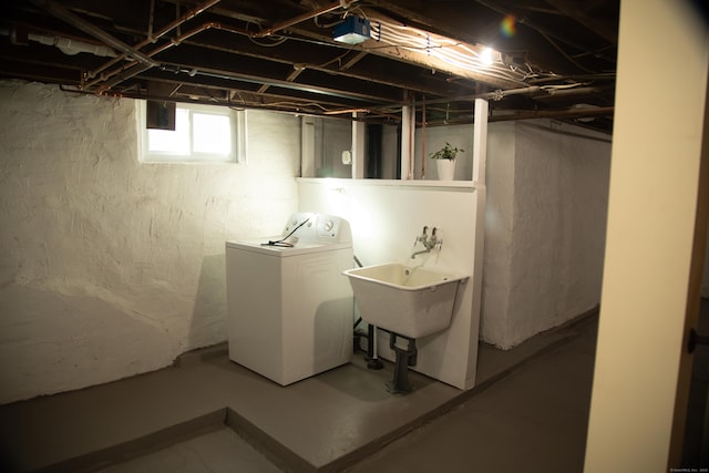 basement featuring washer / dryer and sink