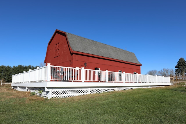 exterior space with a deck and a lawn