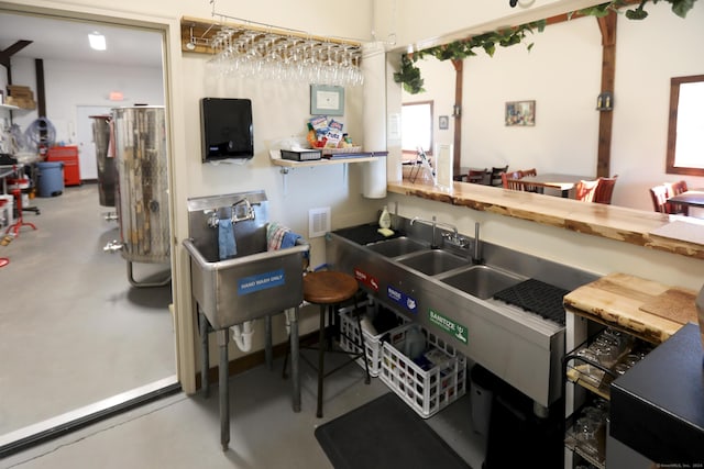 kitchen with concrete flooring and wood counters