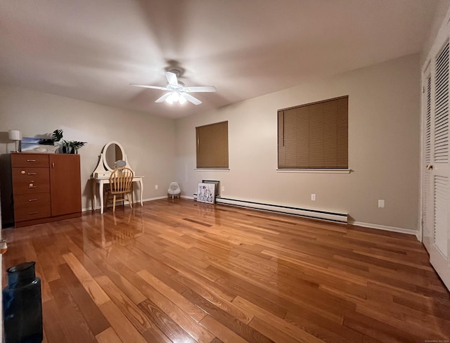 unfurnished bedroom featuring hardwood / wood-style flooring, ceiling fan, a closet, and a baseboard radiator