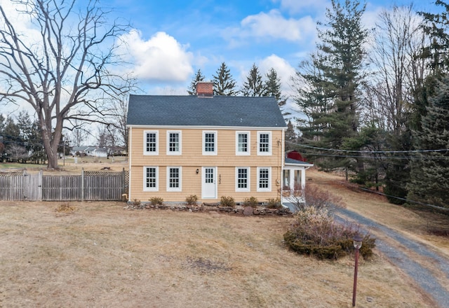 colonial home with a front lawn