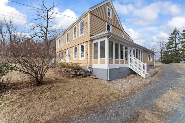 view of side of home with a sunroom