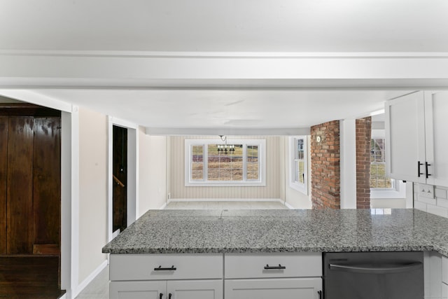 kitchen with white cabinetry, light stone countertops, and black dishwasher