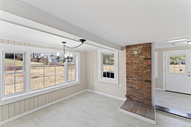 unfurnished dining area with an inviting chandelier and beamed ceiling