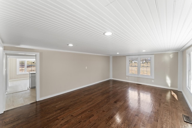 spare room with crown molding and dark hardwood / wood-style floors