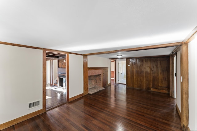 unfurnished living room with dark hardwood / wood-style flooring