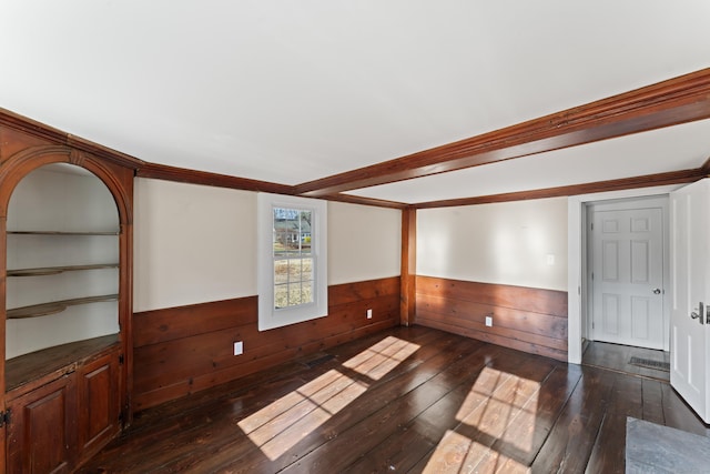 empty room with wooden walls and dark hardwood / wood-style floors