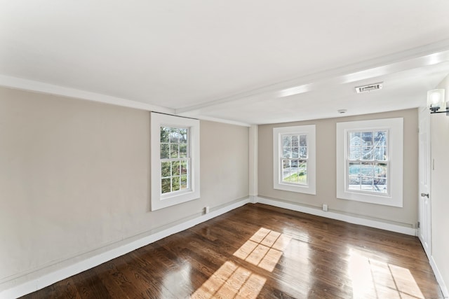 unfurnished room with dark wood-type flooring and plenty of natural light