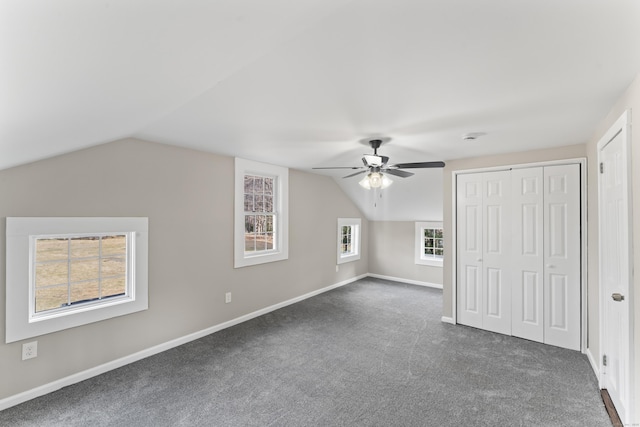 bonus room with ceiling fan, lofted ceiling, and dark carpet