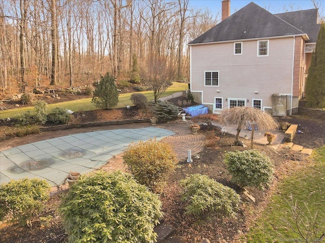 exterior space featuring a covered pool and a patio area