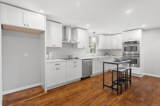 kitchen featuring white cabinetry, dark hardwood / wood-style flooring, wall chimney range hood, and stainless steel appliances