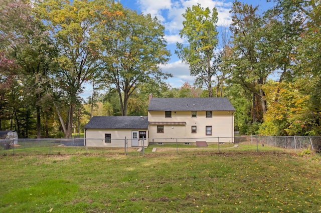 back of property featuring a yard