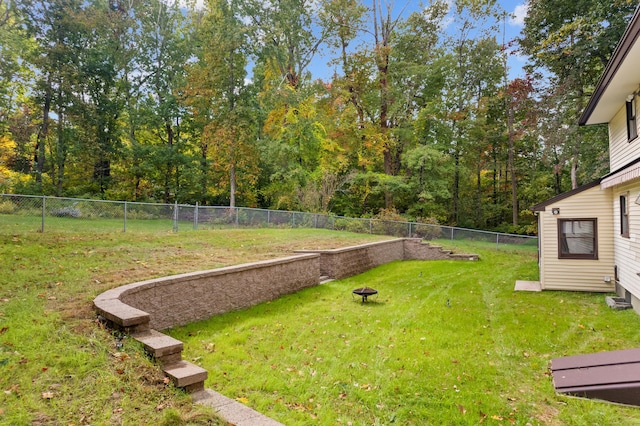 view of yard with a fire pit