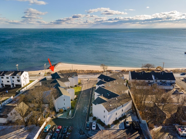 aerial view with a water view and a beach view