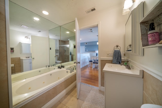 bathroom with vanity, hardwood / wood-style flooring, and separate shower and tub