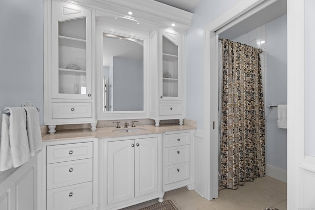 bathroom featuring tile patterned floors, vanity, and walk in shower