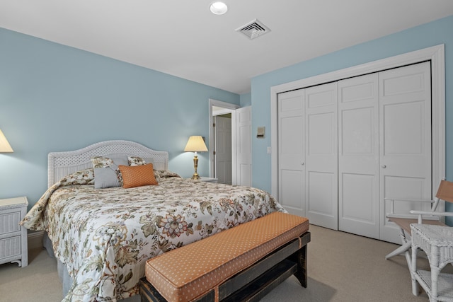 bedroom featuring light carpet and a closet