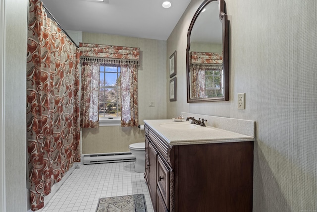 bathroom with tile patterned flooring, vanity, toilet, and a baseboard heating unit