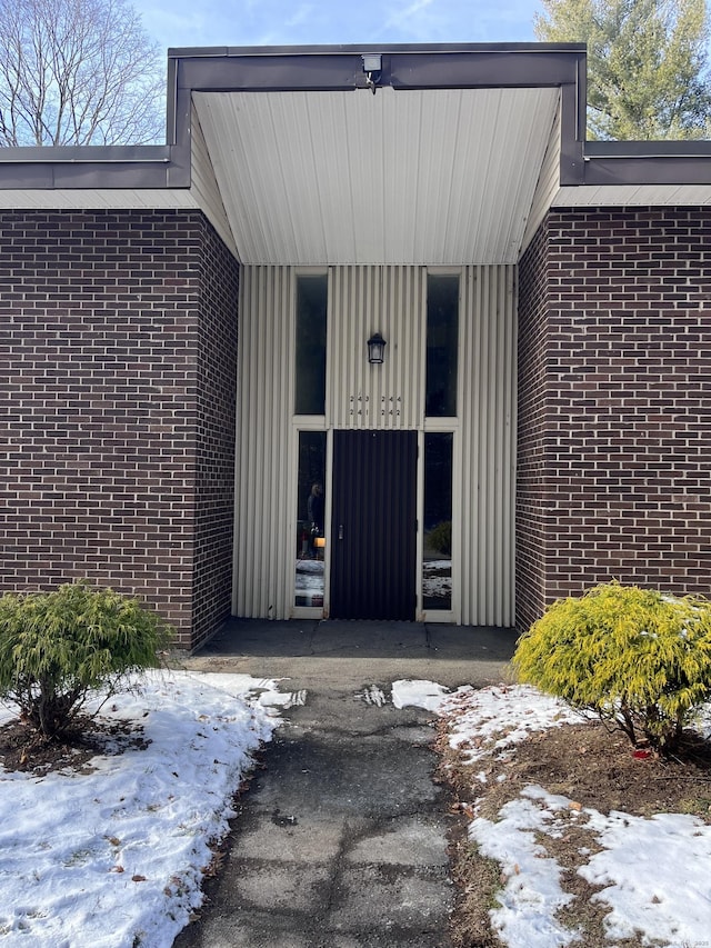 view of snow covered property entrance