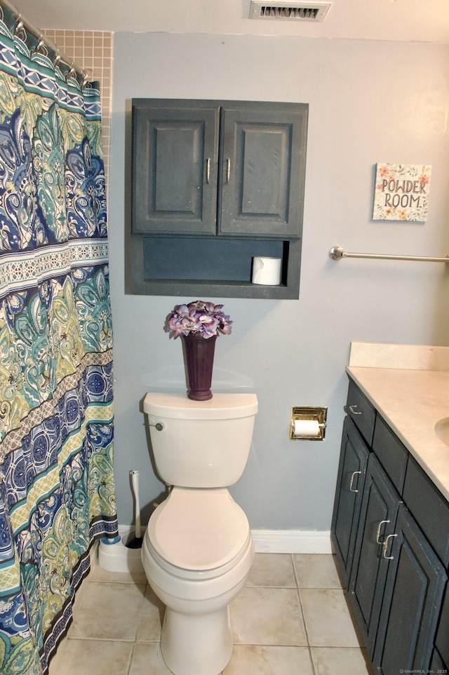 bathroom featuring tile patterned floors, vanity, and toilet