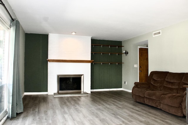 living room featuring wood-type flooring and a fireplace