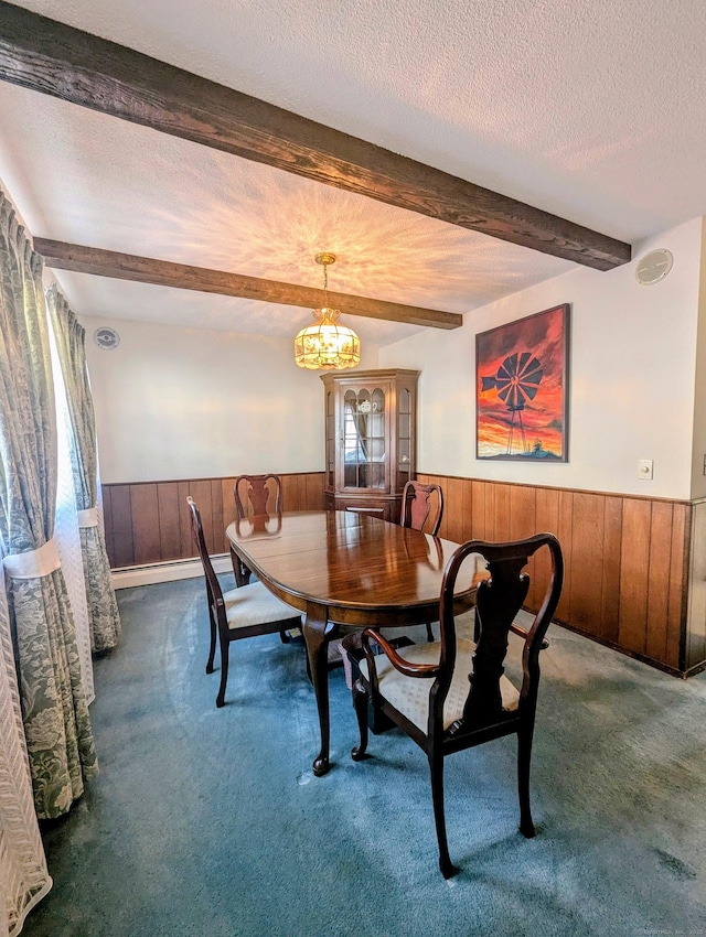 dining space with beamed ceiling, a notable chandelier, a textured ceiling, and dark colored carpet