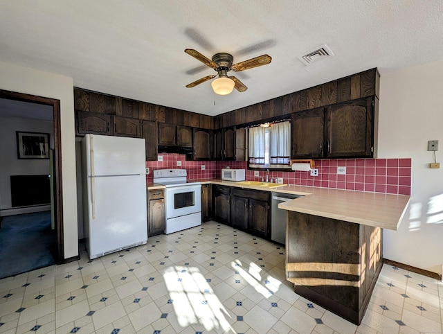 kitchen with sink, white appliances, dark brown cabinets, and a textured ceiling