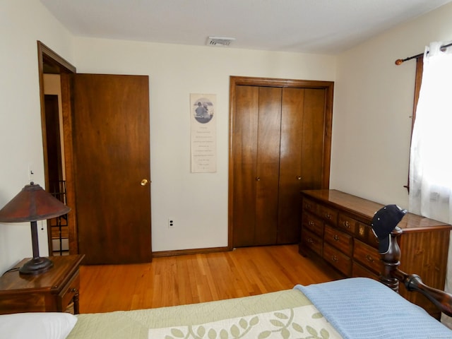 bedroom featuring light wood-type flooring and a closet