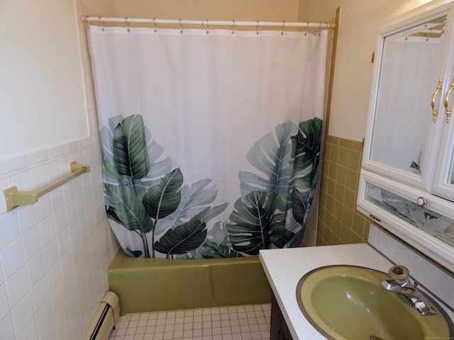 bathroom with shower / bath combo, tile patterned flooring, tile walls, and a baseboard heating unit