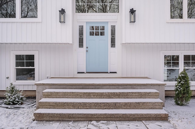 view of snow covered property entrance