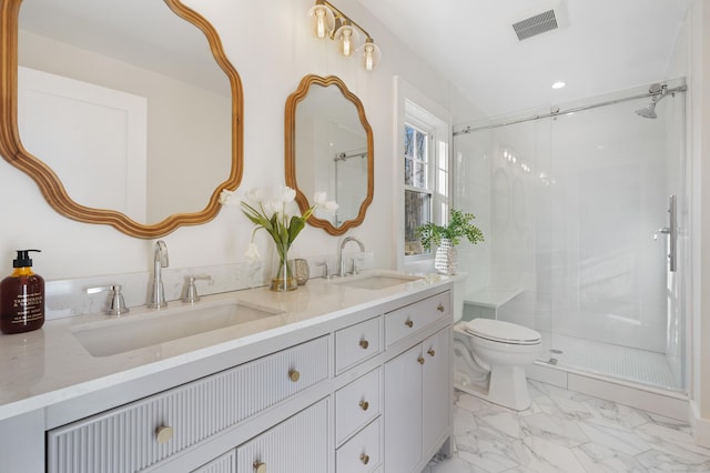 bathroom featuring vanity, toilet, and a shower with door