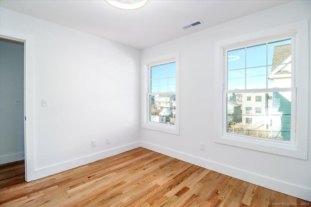 spare room with light hardwood / wood-style flooring