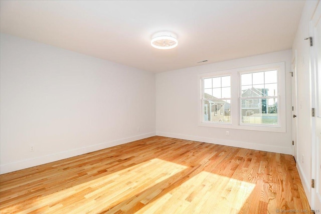 spare room with light hardwood / wood-style flooring