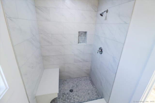 bathroom with tiled shower