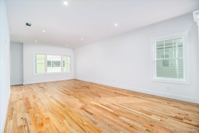 unfurnished room with light hardwood / wood-style flooring