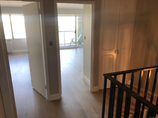 hallway with light hardwood / wood-style flooring