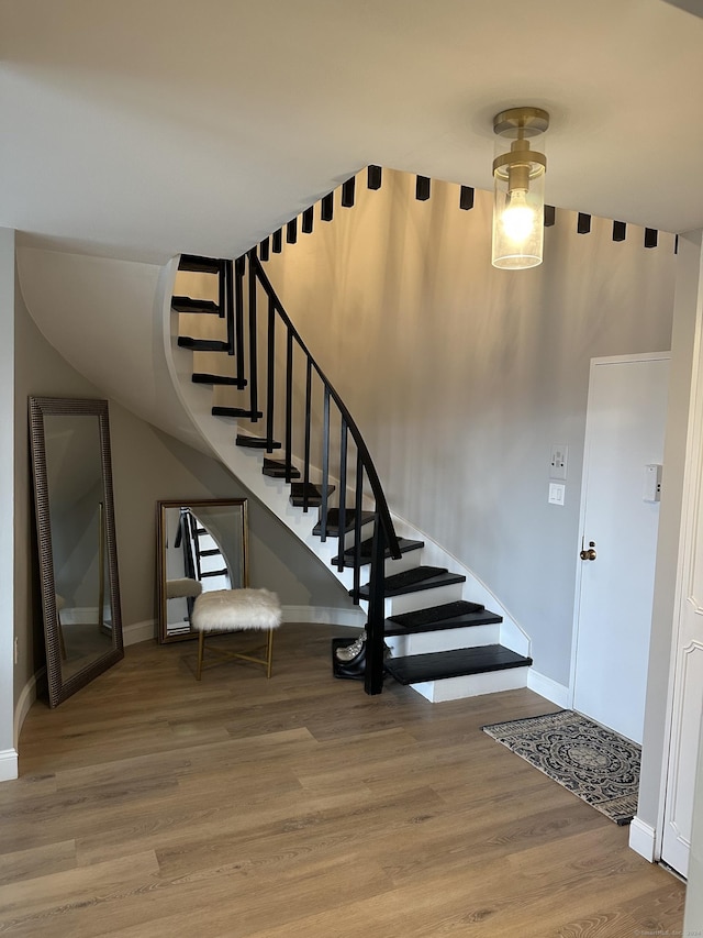 staircase featuring hardwood / wood-style floors