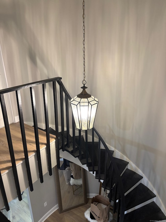 stairs featuring hardwood / wood-style floors