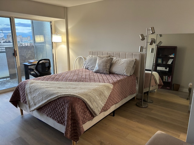 bedroom featuring hardwood / wood-style flooring and access to exterior