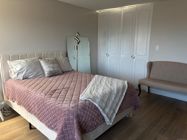 bedroom featuring hardwood / wood-style flooring and a closet